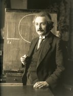Picture of Albert Einstein standing at a chalkboard